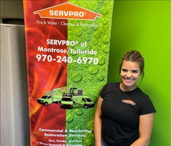 employee female posing in black SERVPRO polo shirt