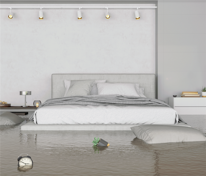 a flooded bedroom with items floating everywhere