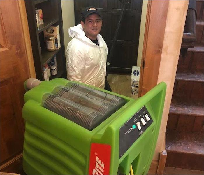 SERVPRO employee with a water extraction machine