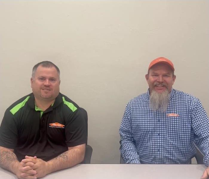 two SERVPRO employees sitting at a table